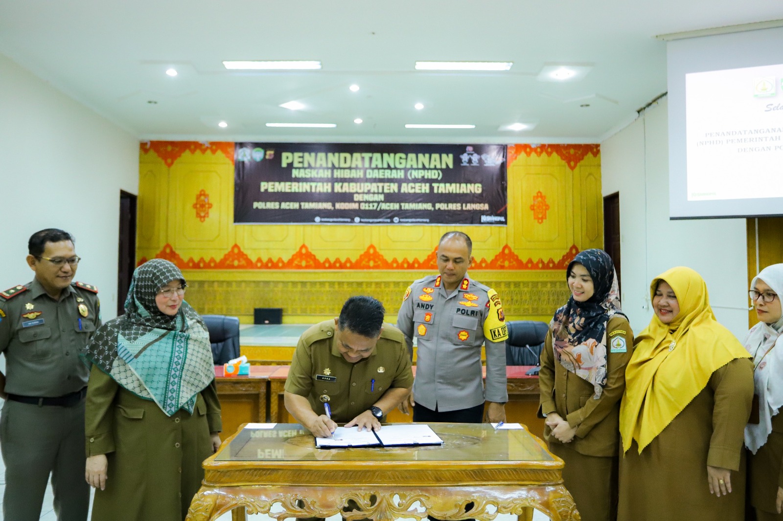 Teks foto : Penjabat (Pj) Bupati Aceh Tamiang Drs. Asra saat melakukan penandatanganan Naskah Perjanjian Hibah Daerah (NPHD) dengan Polres Aceh Tamiang, Kodim 0117/Aceh Tamiang dan Polres Langsa, di aula Setdakab, Senin (22/1).